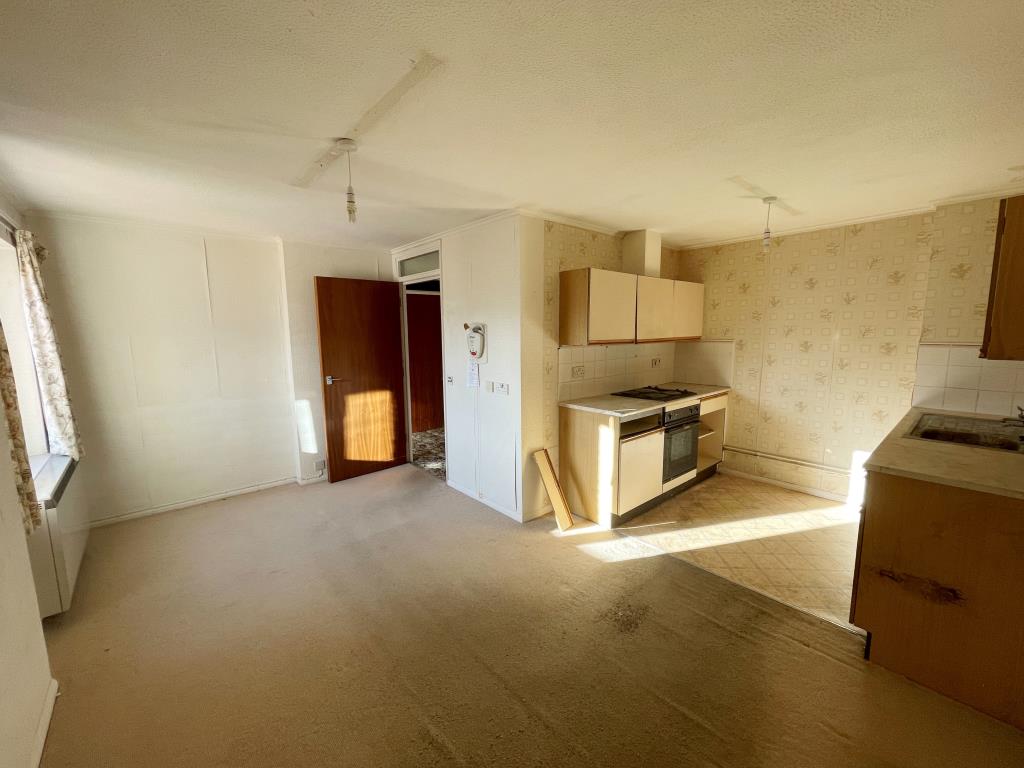 Lot: 33 - ONE-BEDROOM FLAT FOR IMPROVEMENT - Living room with kitchen